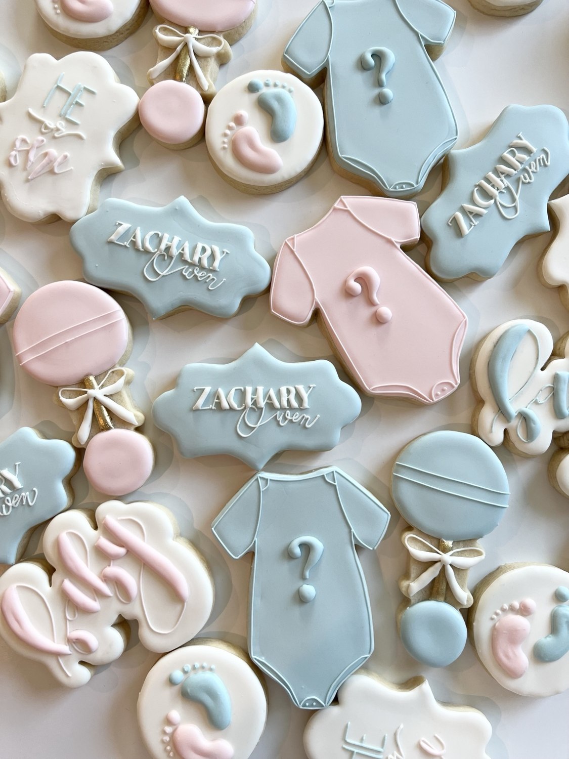 Delicately decorated pink and blue baby shower cookies